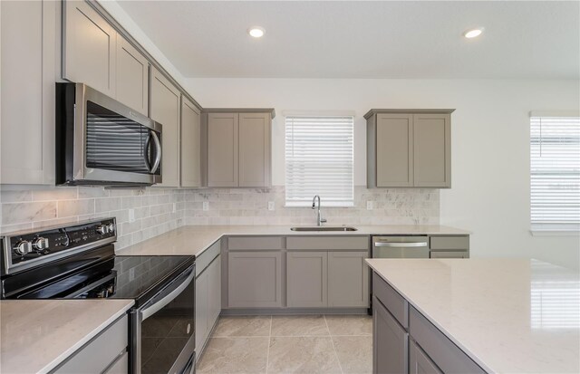 kitchen featuring stainless steel appliances and gray cabinetry