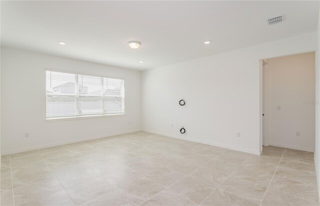 unfurnished room with recessed lighting, visible vents, and baseboards