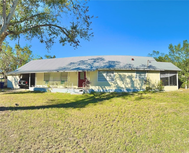 view of front of property with a front lawn and a carport