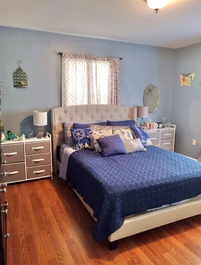 bedroom with wood-type flooring