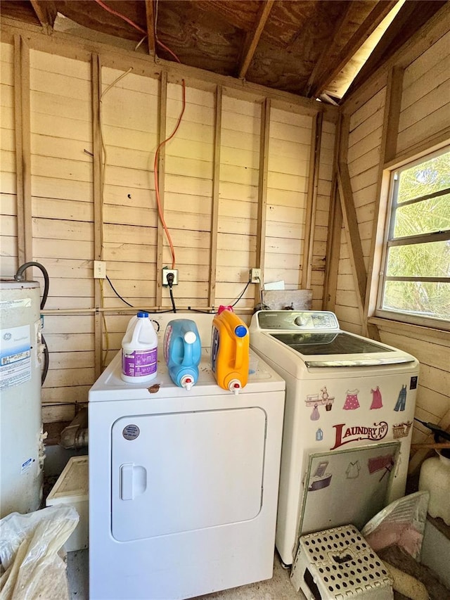 laundry room featuring independent washer and dryer and wood walls