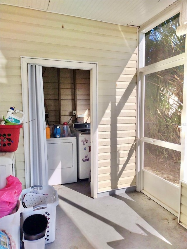 sunroom with washer and clothes dryer