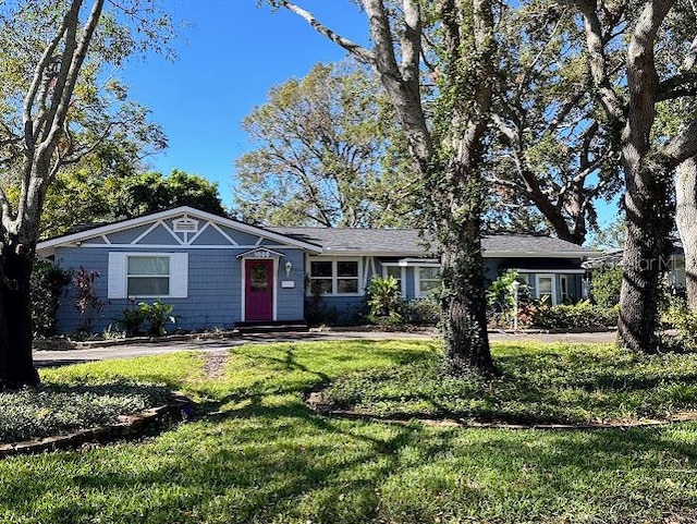 ranch-style home with a front lawn