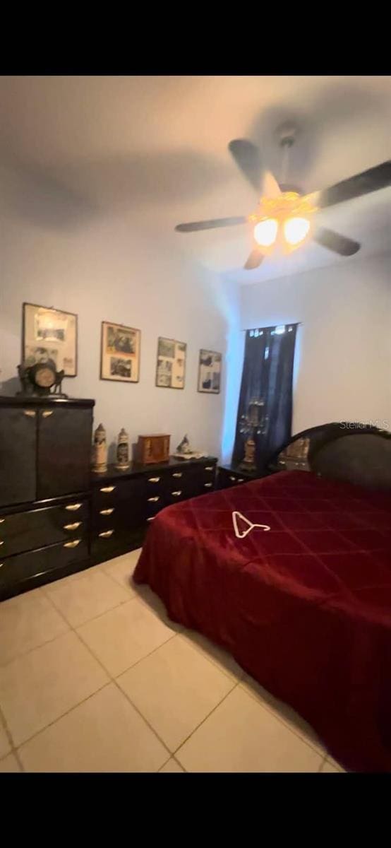 bedroom featuring tile patterned floors and ceiling fan