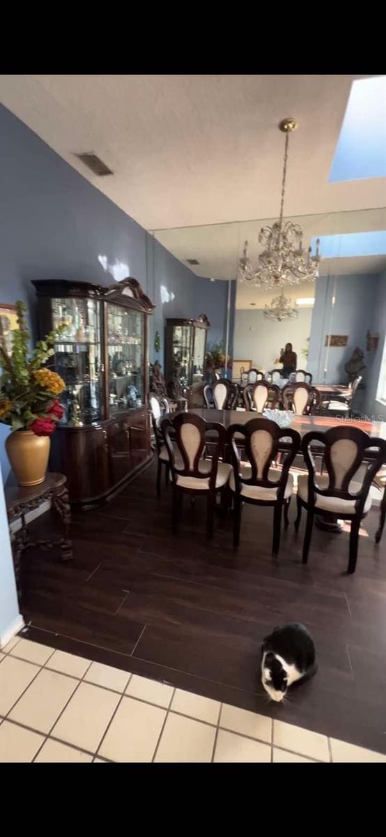 unfurnished dining area with an inviting chandelier