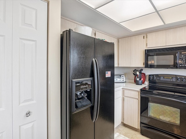 kitchen featuring light brown cabinets and black appliances