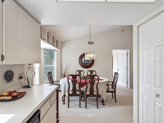 dining space with light carpet, an inviting chandelier, and lofted ceiling