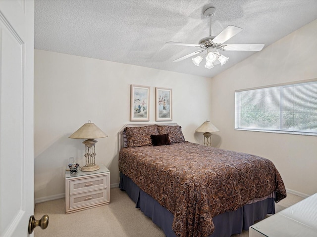 bedroom with a textured ceiling, ceiling fan, light carpet, and vaulted ceiling