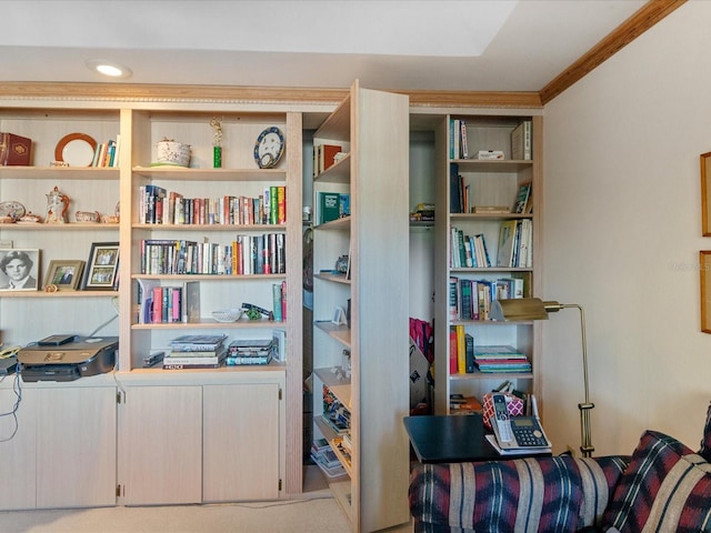 sitting room featuring crown molding and light colored carpet