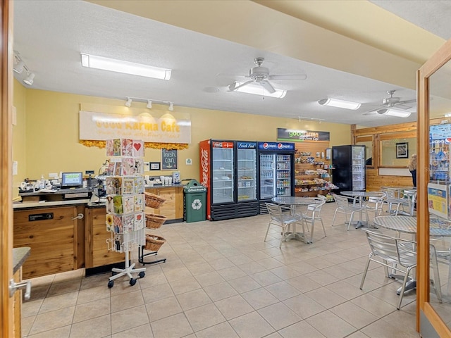 2231 Utopian Dr E Unit 321, Clearwater, FL 33763 - home office with track lighting, ceiling fan, light tile patterned flooring, and a textured ceiling