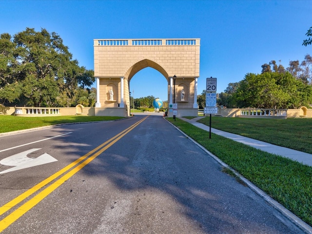 2231 Utopian Dr E Unit 321, Clearwater, FL 33763 - view of asphalt road with traffic signs, curbs, and sidewalks