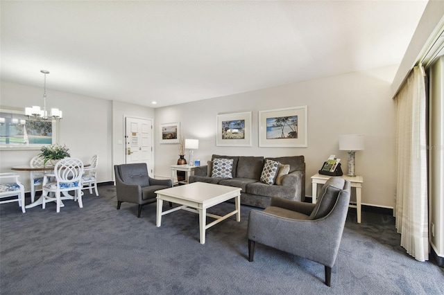 living room with dark colored carpet and a notable chandelier