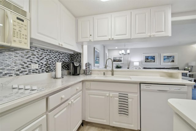 kitchen featuring white cabinets and white appliances