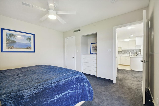 carpeted bedroom featuring ensuite bathroom and ceiling fan