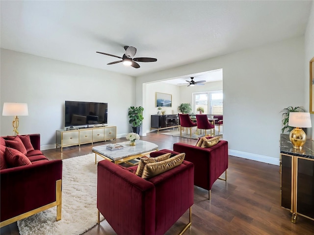 living room with ceiling fan and dark wood-type flooring