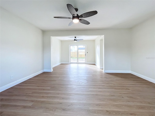 unfurnished room with light wood-type flooring and ceiling fan