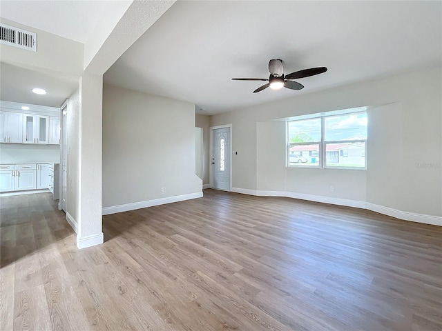 unfurnished living room featuring ceiling fan and light hardwood / wood-style flooring