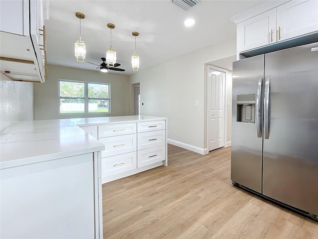 kitchen with light stone countertops, white cabinetry, ceiling fan, stainless steel refrigerator with ice dispenser, and light hardwood / wood-style floors