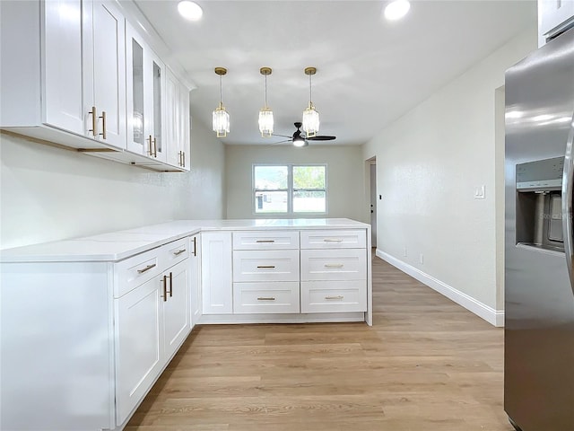 kitchen with white cabinetry, ceiling fan, stainless steel refrigerator with ice dispenser, kitchen peninsula, and light wood-type flooring