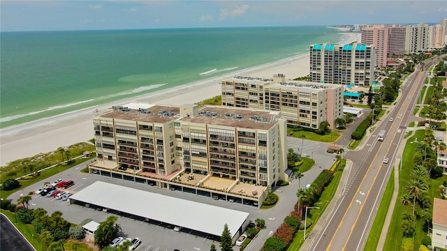 drone / aerial view featuring a water view and a view of the beach