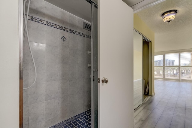 interior space featuring a tile shower and a textured ceiling