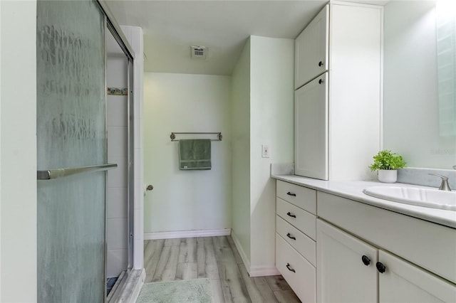 1430 Gulf Blvd Unit 204, Clearwater Beach, FL 33767 - bathroom with vanity, wood finished floors, a shower stall, and baseboards