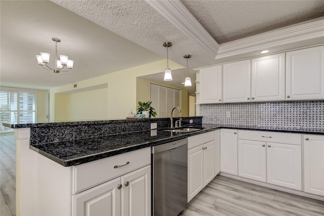 kitchen with dishwasher, a peninsula, backsplash, and a sink