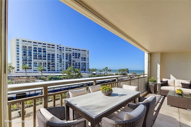 balcony featuring a water view and an outdoor hangout area