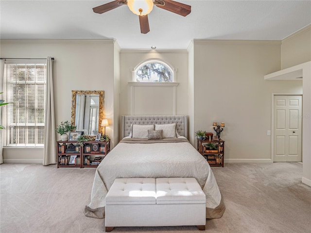 carpeted bedroom featuring a closet, ceiling fan, and crown molding