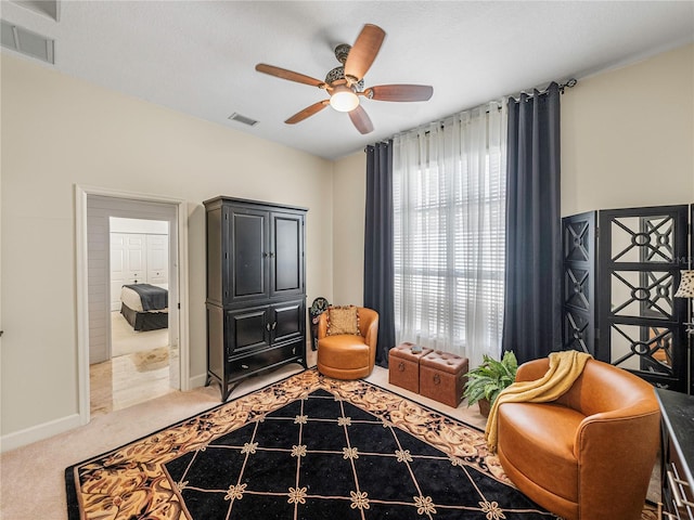 sitting room with carpet flooring and ceiling fan