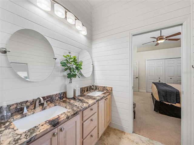 bathroom with wooden walls, vanity, and ceiling fan