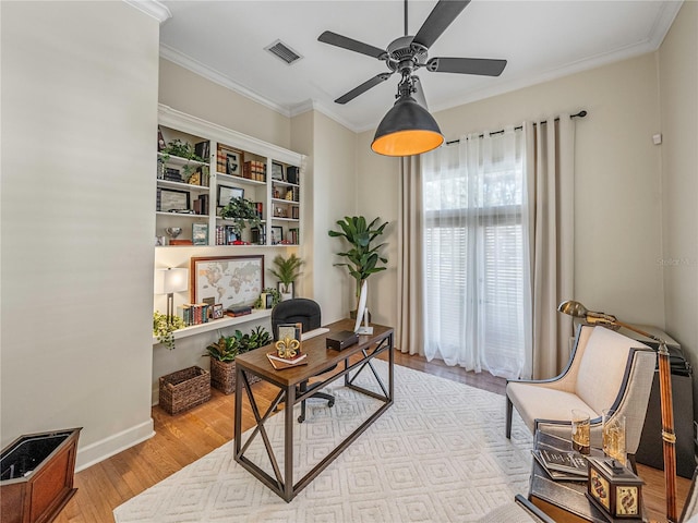 office space featuring light hardwood / wood-style flooring, ceiling fan, and crown molding