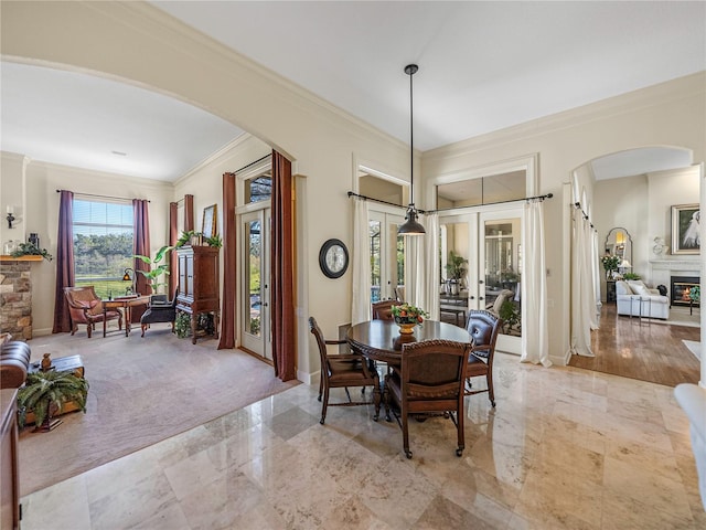 carpeted dining room featuring french doors and ornamental molding