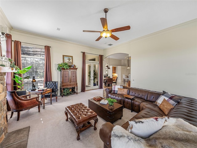 living room featuring light colored carpet, ceiling fan, and crown molding