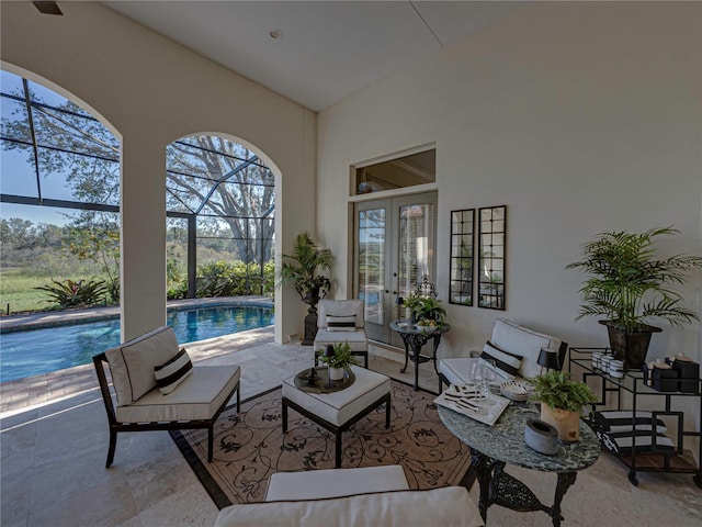 view of patio with glass enclosure, an outdoor hangout area, and french doors