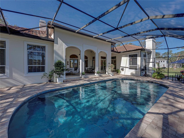 view of swimming pool with a lanai and a patio area