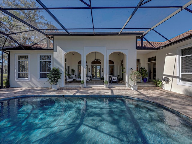 view of pool featuring a lanai, ceiling fan, and a patio area