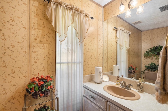 bathroom with an inviting chandelier and vanity