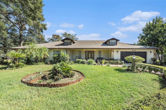 ranch-style home featuring a front yard and a garage