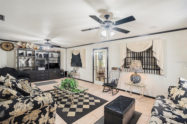 tiled bedroom featuring ornamental molding, ceiling fan, and a textured ceiling