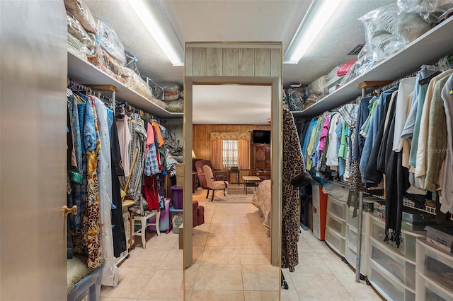 spacious closet featuring light tile patterned flooring