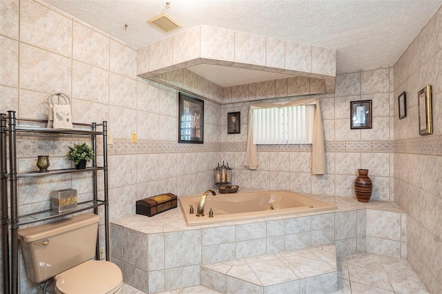 bathroom featuring tiled tub, tile walls, a textured ceiling, and toilet