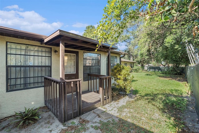 property entrance with a lawn