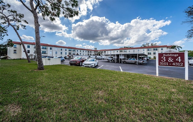 view of car parking featuring a lawn