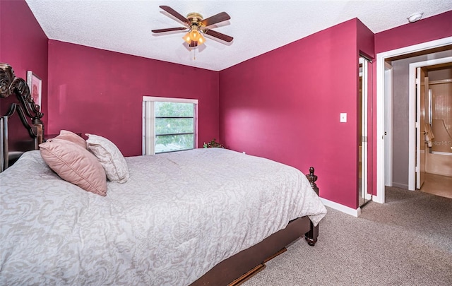 bedroom featuring carpet, a textured ceiling, ensuite bath, and ceiling fan