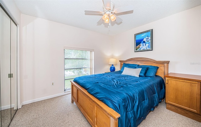 2700 Bayshore Blvd Unit 4304, Dunedin, FL 34698 - bedroom with light colored carpet, a textured ceiling, baseboards, and a ceiling fan