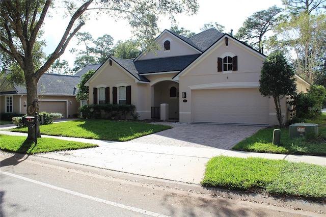 view of front of home with a front yard and a garage