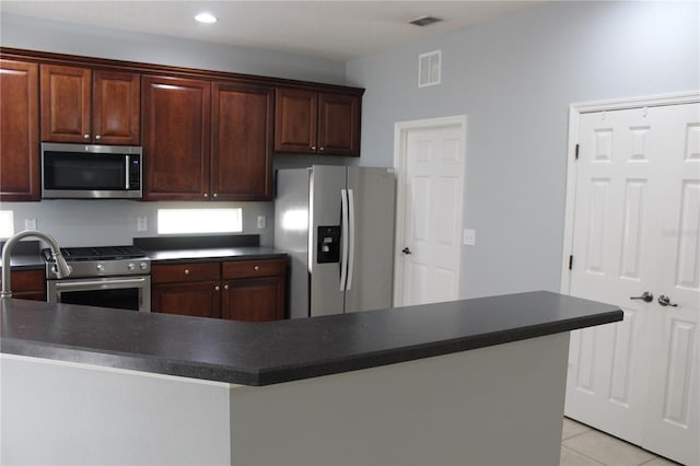 kitchen featuring light tile patterned floors and stainless steel appliances