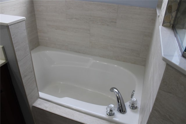 bathroom featuring tiled tub