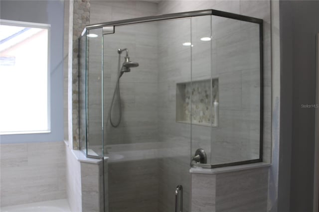 bathroom featuring a shower with shower door